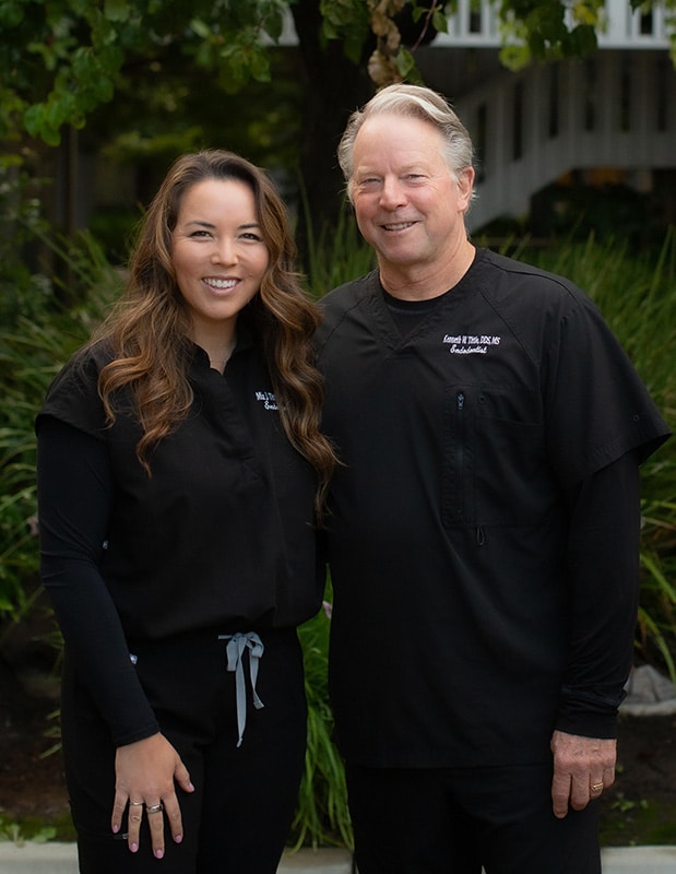 Dr Mia and Dr Ken Tittle in hallway with diplomas