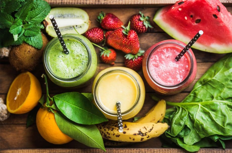 fruit and smoothies on a wooden tray