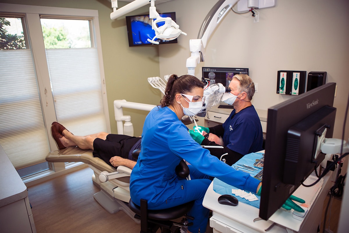 Dentist and assistant working on patient