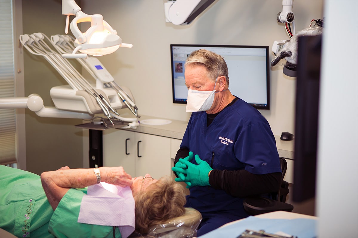 Dentist speaking with patient