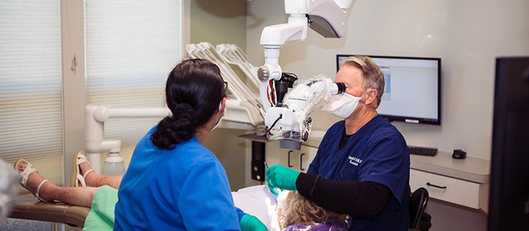 doctor and assistant chairside in a high tech dental office